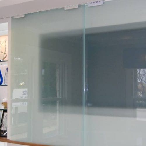 Sliding Glass Wall at Television in Conference Room | Glass Wall Systems Gallery | Interior Glass Products | Anchor-Ventana Glass